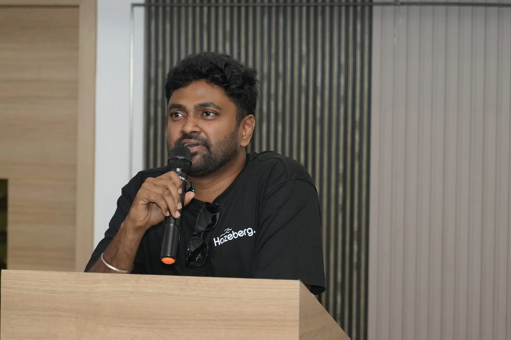 A team member speaking at the podium at the 2026 offsite