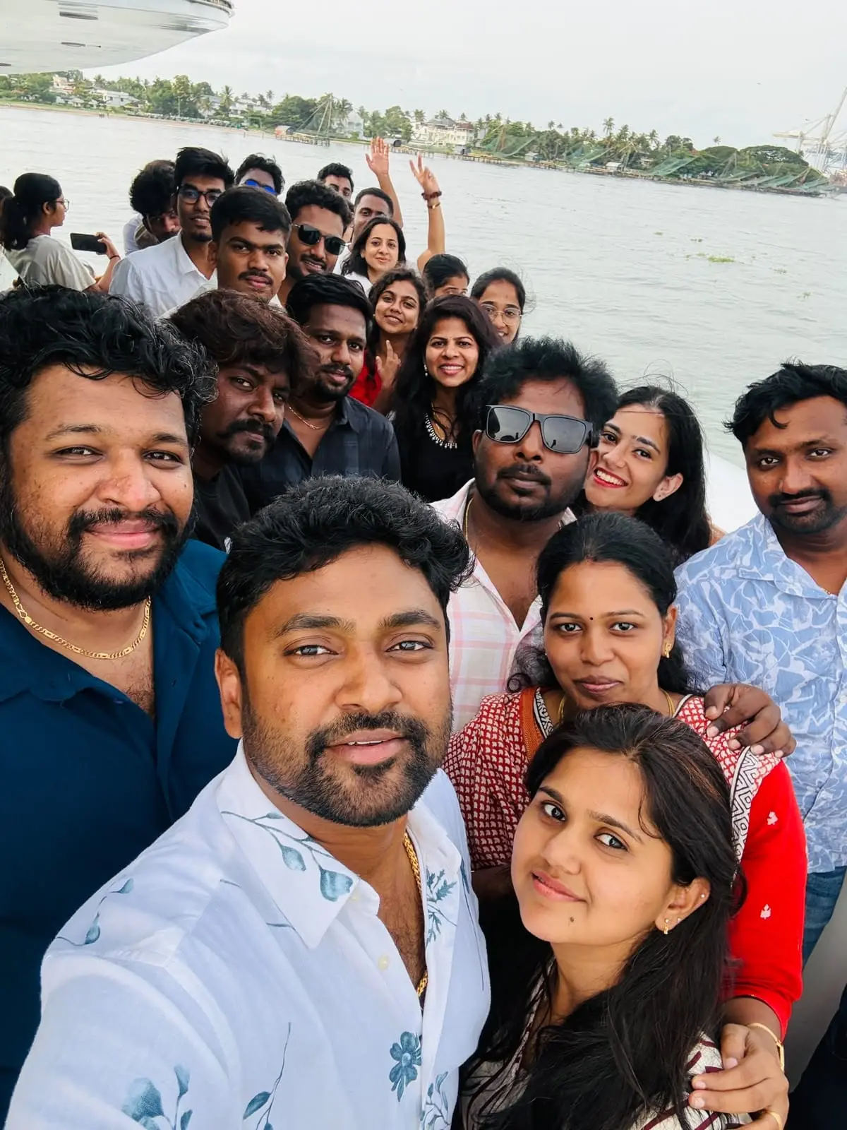 A team selfie by the water at the 2026 offsite