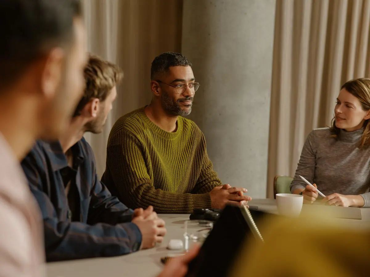 Consultants working together around a table in a meeting room